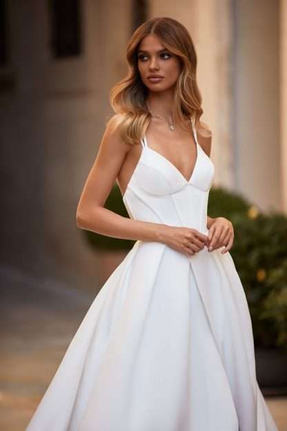 Cornelia Milla Nova Wedding Dress. Plain satin aline bridal gown with corset detail and spaghetti strap