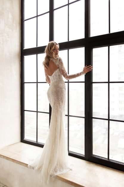 Celine Eva Lendel Wedding dress. Fully beaded high neck wedding dress with small puddle train and long sleeves.