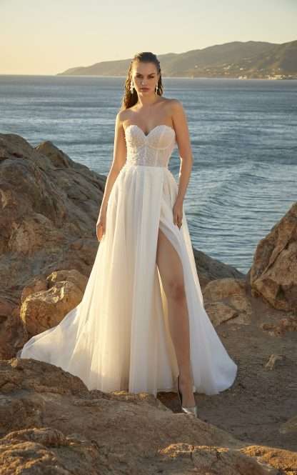 Melissa 15037  Morilee wedding dress. Strapless wedding dress with pearl detailing and tulle ruched bodice. Soft aline flowy skirt and a detachable pearl detail cape for arm coverage and that important 2 looks in 1! Chameleon Bride Bournemouth Dorset