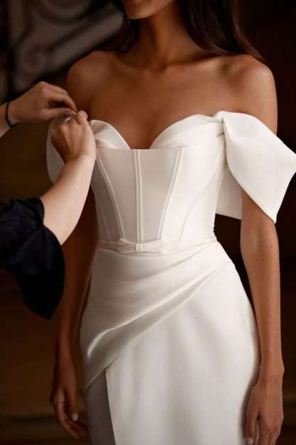Cora Lorenzo Rossi Milla Nova. Corset boned structured off shoulder strapless wedding dress with skirt split. Chameleon Bride Bournemouth Dorset