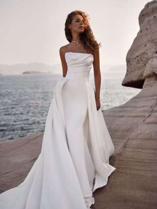 Olimpia Milla Nova. Strapless ruched plain fitted satin wedding dress with detachable overskirt. Chameleon Bride Bournemouth Dorset