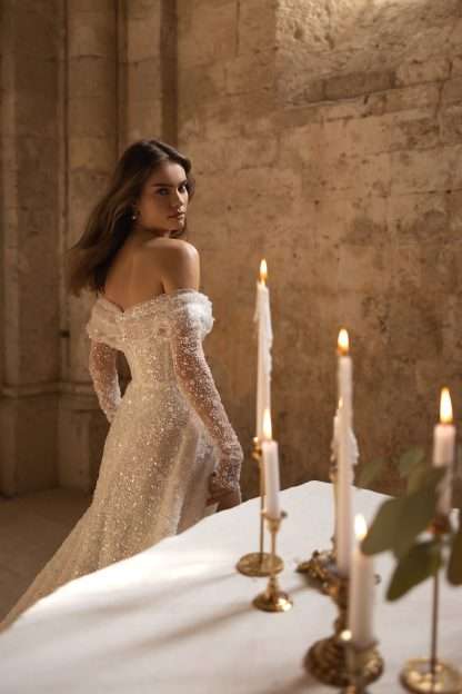 Dita Eva Lendel wedding dress. Off shoulder bardot fully beaded sparkle bridal gown with detachable long sleeve cuff. Chameleon Bride Bournemouth Dorset