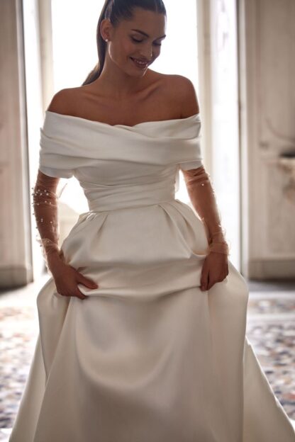 Eridana Milla Nova wedding dress. Satin plain simple mikado strapless bridal gown with detachable bardot bolero with long beaded sleeves. Chameleon Bride Bournemouth Dorset
