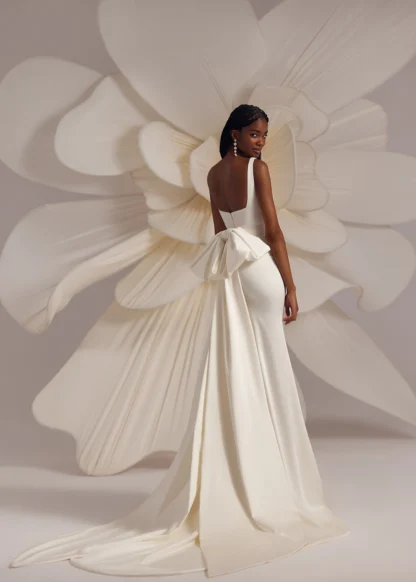 Eva Lendel Bertie Plain Square neck thick strap fitted sheath gown, statement bow. Wedding Dress with low square back. Chameleon Bride Bournemouth Dorset