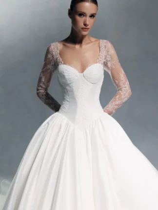 Devotion by Wona Concept Wedding dress. Long lace sleeve bridal gown with structured bodice, v basque drop waist, corset amd ballgown skirt. Chameleon Bride Bournemouth Dorset